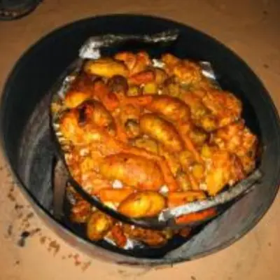 a dish of food in a pan on a table at Traditions of Wadi Rum camp & jeep tour in Wadi Rum