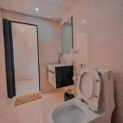 a bathroom with a toilet with the lid up at Traditions of Wadi Rum camp & jeep tour in Wadi Rum