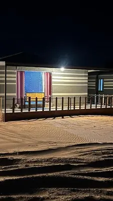 a train is parked next to a fence at Traditions of Wadi Rum camp & jeep tour in Wadi Rum