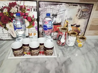a table with bottles of water and jars and flowers at Basant Villa in Wadi Musa