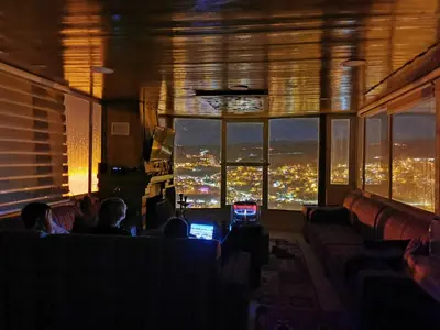 a group of people sitting in a room with a view at Basant Villa in Wadi Musa