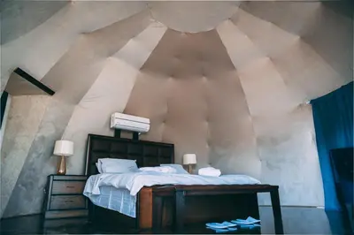 a bedroom with a large bed in a attic at Zeina Desert Lodge in Wadi Rum