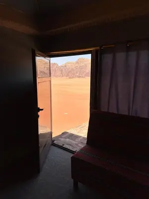 a room with a view of the desert from a window at Wadi rum Bedouin Experience in Wadi Rum