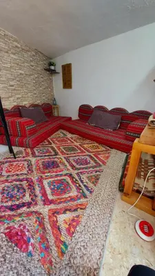 a room with a large rug on the floor at Our Villa's Pine Cottage - HQ Budget Stay - Wonderful horizon view of Jerash in Jerash