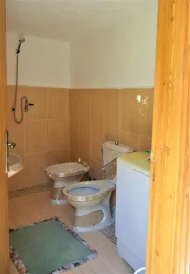 a bathroom with two toilets and a sink at Our Villa's Pine Cottage - HQ Budget Stay - Wonderful horizon view of Jerash in Jerash