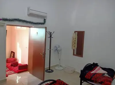 a living room with a door and a fan at Idris home in Wadi Musa