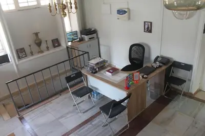 an office with a desk and chairs in a room at Cairwan Hotel in Kerak