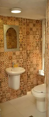 a bathroom with a sink and a toilet at Cairwan Hotel in Kerak