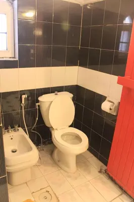 a bathroom with a toilet and a bidet at Cairwan Hotel in Kerak