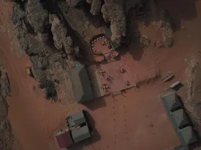 an overhead view of a beach with a group of vehicles at Sand Star Camp in Wadi Rum