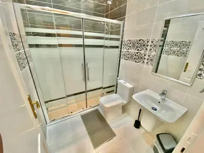 a bathroom with a shower and a toilet and a sink at Villa Mira Guesthouse 1 - Downtown Central Amman - AL DIYRIH in Amman
