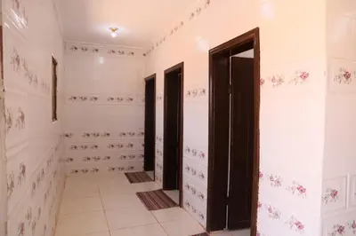 a bathroom with white walls and black doors at Desert shine camp in Wadi Rum