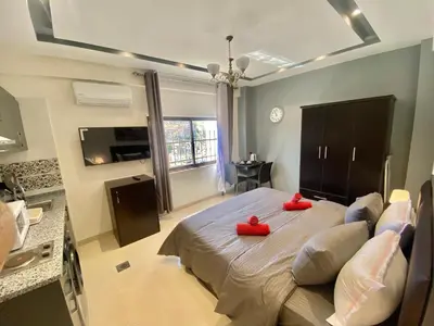 a bedroom with a bed with red pillows on it at Villa Mira GuestHouse 2 - Downtown Central Amman - AL DIYRIH in Amman