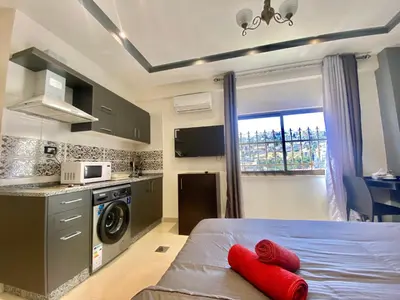 a bedroom with a bed with red pillows on it at Villa Mira GuestHouse 2 - Downtown Central Amman - AL DIYRIH in Amman