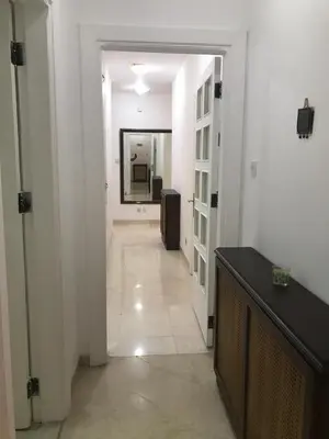 a hallway with a hallway leading to a room at Nice Furnished apartment in Amman
