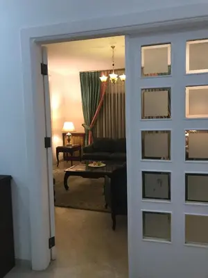 a living room with a door open to a living room at Nice Furnished apartment in Amman