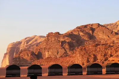 a mountain with four tunnels in front of a mountain at Desert Bedouin camp in Wadi Rum