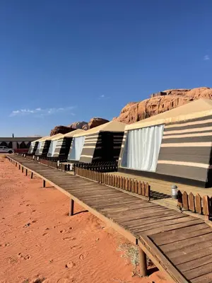 a row of tents sitting in the desert at Discover the life of Wadi Rum camp in Wadi Rum