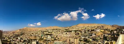 a view of a city with buildings on a hill at Rakan ApartHotel and Luxury Rooms in Wadi Musa