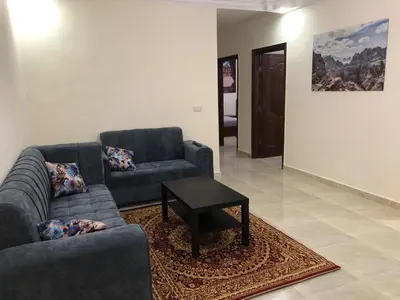 a living room with two couches and a coffee table at Rakan ApartHotel and Luxury Rooms in Wadi Musa