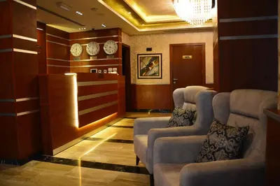 a waiting room with two chairs and a bar at سما عمان للشقق الفندقية Sama Amman Hotel Apartments in Amman