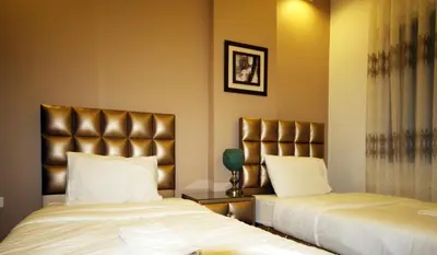 a hotel room with two beds and a headboard at سما عمان للشقق الفندقية Sama Amman Hotel Apartments in Amman