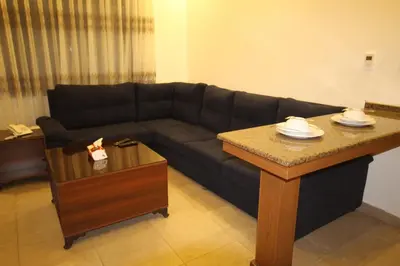 a living room with a couch and a table at سما عمان للشقق الفندقية Sama Amman Hotel Apartments in Amman