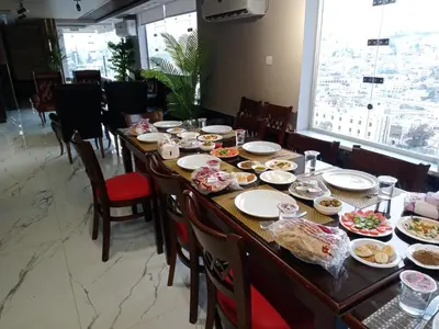 a long table with food on it in a restaurant at Petra Monastery Tourist Hotel in Wadi Musa