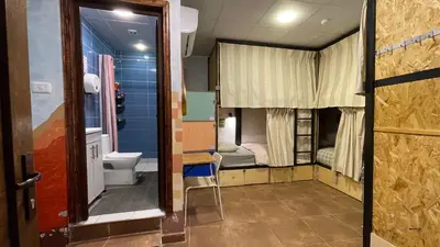 a room with a bathroom with a toilet and a sink at Carob Hostel in Amman