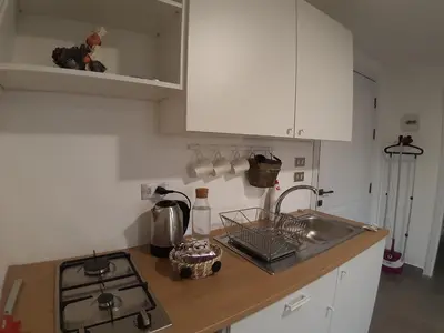 a kitchen counter with a sink and a stove at The Place in Madaba