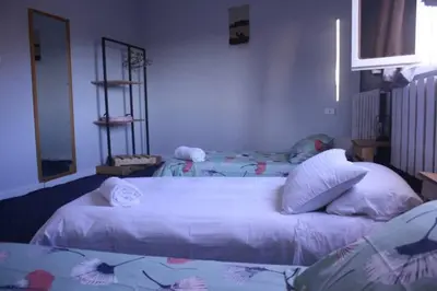 a bedroom with two beds with white sheets and pillows at Petra Main Gate in Wadi Musa