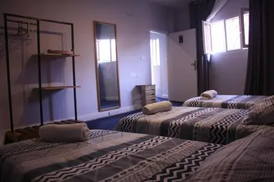 a room with two beds and two windows at Petra Main Gate in Wadi Musa