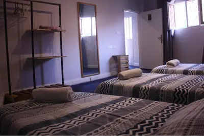 a room with three beds in a room at Petra Main Gate in Wadi Musa