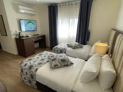 a hotel room with two beds and a couch at Petra Heart Hotel in Wadi Musa