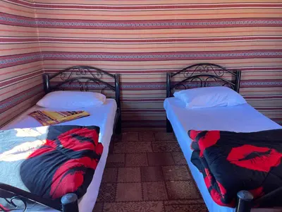 two beds sitting next to each other in a room at Quite bedouin life in Wadi Rum
