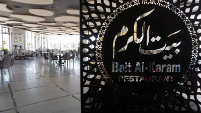 a dining hall with a sign in a restaurant at Opal Hotel Amman in Amman