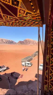 a view of a desert with cars parked in a parking lot at Walid Bedouin Camp in Wadi Rum