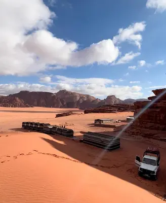 a group of cars parked in the desert at Walid Bedouin Camp in Wadi Rum