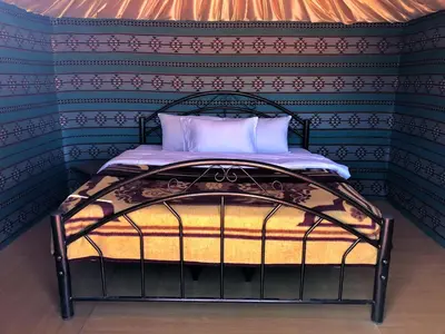 a bed in a room with a wall at Wadi rum desert breath in Wadi Rum