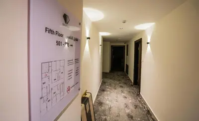 a hallway with a wall with writing on it at Diamond Hotel in Amman
