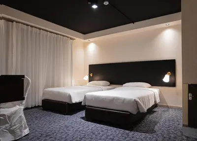 a hotel room with two beds and a large headboard at Diamond Hotel in Amman