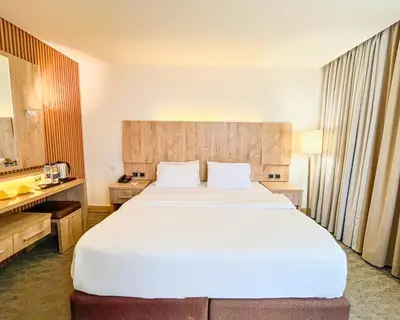 a large white bed in a hotel room at La Casa Hotel Amman by FHM in Amman