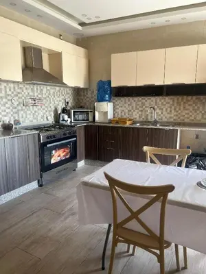 a kitchen with a table and a stove at The Pearl of Jerash in Jerash