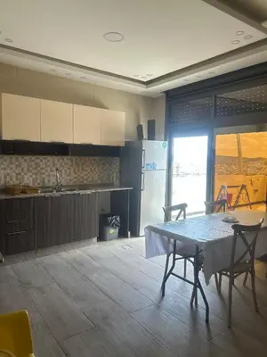 a kitchen with a table and chairs in a room at The Pearl of Jerash in Jerash