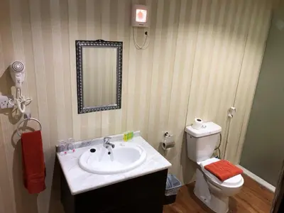 a bathroom with a sink and a toilet and a mirror at Sharah Luxury Camp in Wadi Rum
