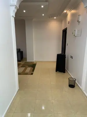 an empty hallway with a suitcase sitting on the floor at Oskar Appartment 2 in Wadi Musa