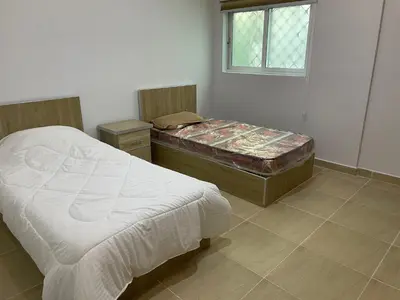 a bedroom with two beds and a window at Oskar Appartment 2 in Wadi Musa
