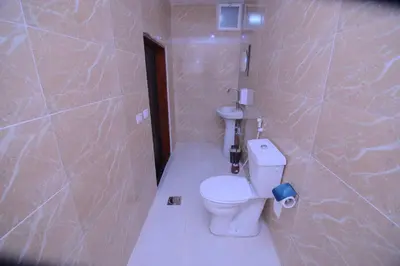 a bathroom with a toilet and a sink at Petra Lion Hotel in Wadi Musa