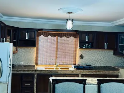 a kitchen with a sink and a window at شقق الياسمين in Jerash