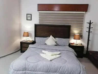 a bedroom with a large bed with two towels on it at Jasmine's House in Jerash